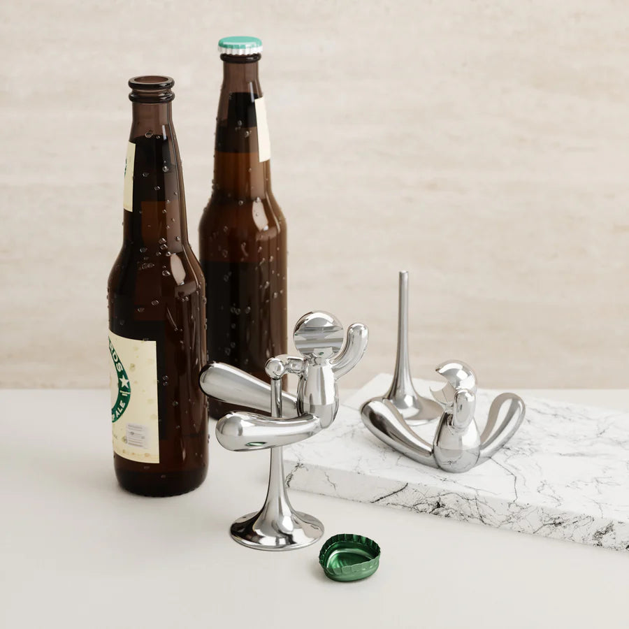 Rodeo Buddy opener chrome on wooden surface with beer bottles