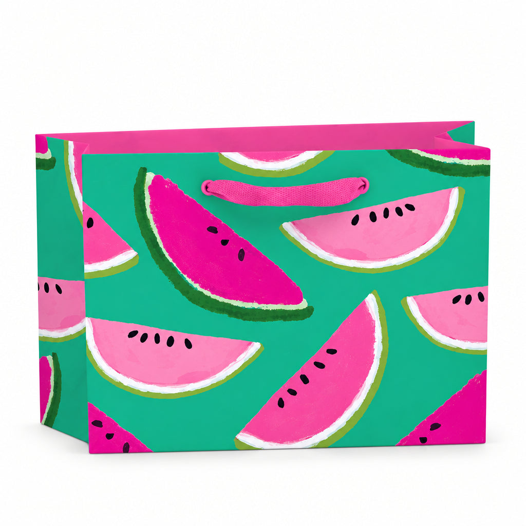 Small recyclable watermelon gift bag featuring Anne Bentley’s pink and green fruit illustrations on a bright teal background, with grosgrain ribbon handles and matching tag.