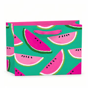Small recyclable watermelon gift bag featuring Anne Bentley’s pink and green fruit illustrations on a bright teal background, with grosgrain ribbon handles and matching tag.