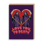 Purple card with two hooded reapers holding hands inside a red heart