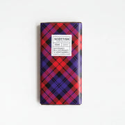 Chocolate bar with plaid packaging and berries on a white background