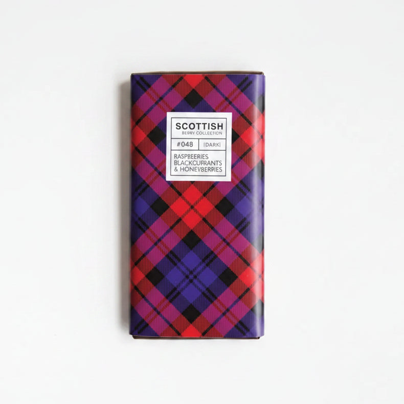 Chocolate bar with plaid packaging and berries on a white background