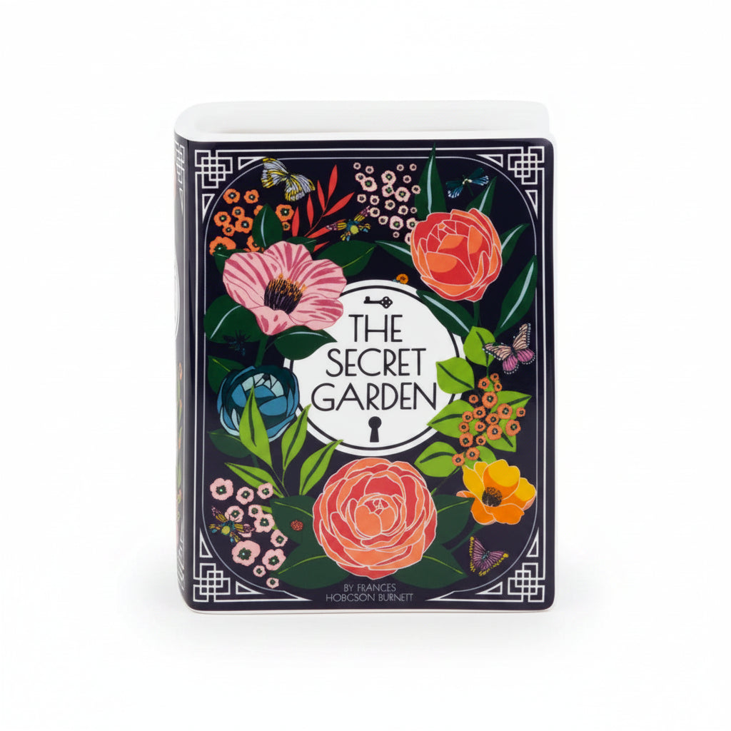 Angled view of Secret Garden ceramic vase shaped like a book with colourful botanical illustrations.