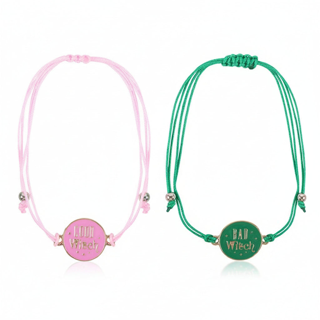 Pink Good Witch bracelet and green Bad Witch bracelet laid flat.