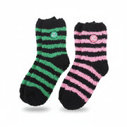 Green and pink striped witch-themed fluffy socks laid flat – Good Witch and Bad Witch design.