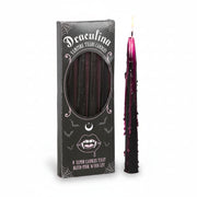 Box of Vampire Tears candles with one black taper candle lit and bleeding pink wax down the sides – spooky Halloween decor.