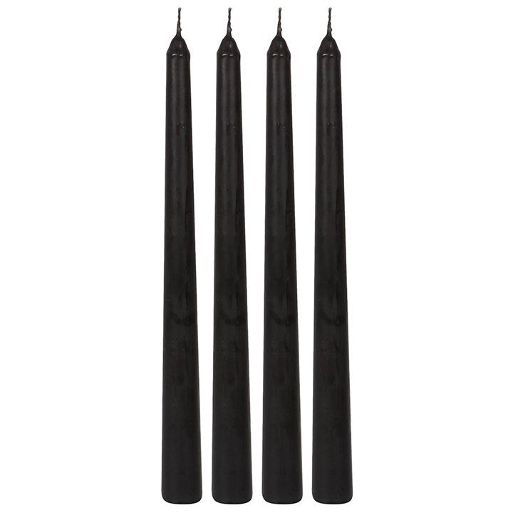 Set of four black gothic taper candles with pointed wicks, unlit and standing upright on a white background.