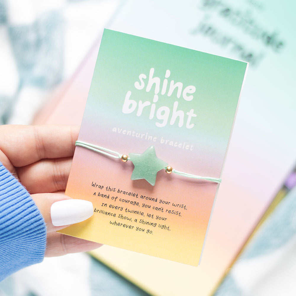 Shine Bright aventurine star bracelet on gradient card held in hand