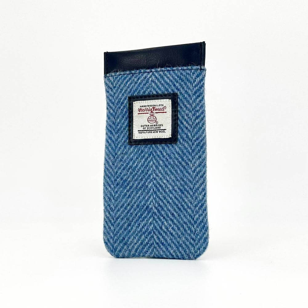 Angled view of sky blue Harris Tweed glasses sleeve showing texture and label detail.