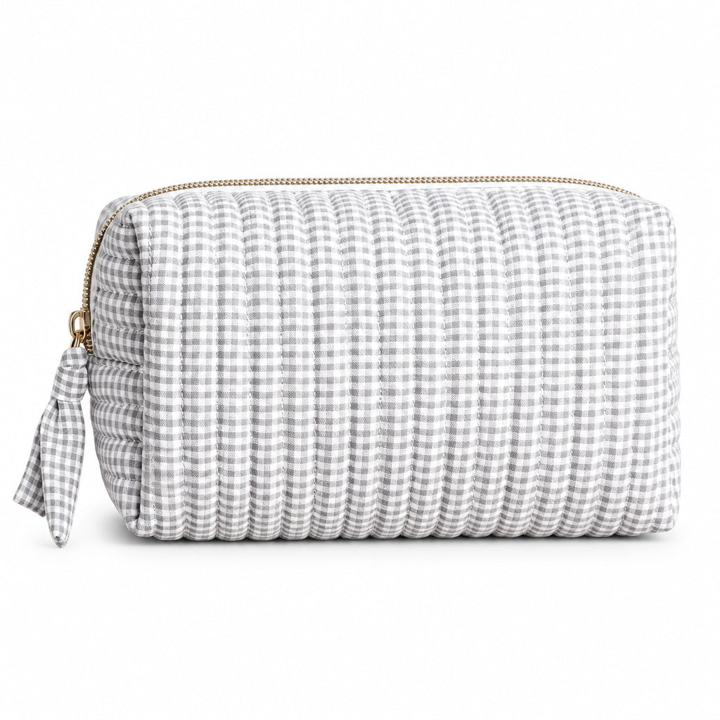 Grey and white gingham travel bag with gold zip displayed on neutral background.