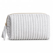 Grey and white gingham travel bag with gold zip displayed on neutral background.
