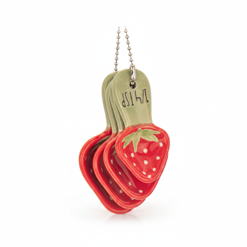 Four ceramic strawberry measuring spoons nested on silver bead chain
