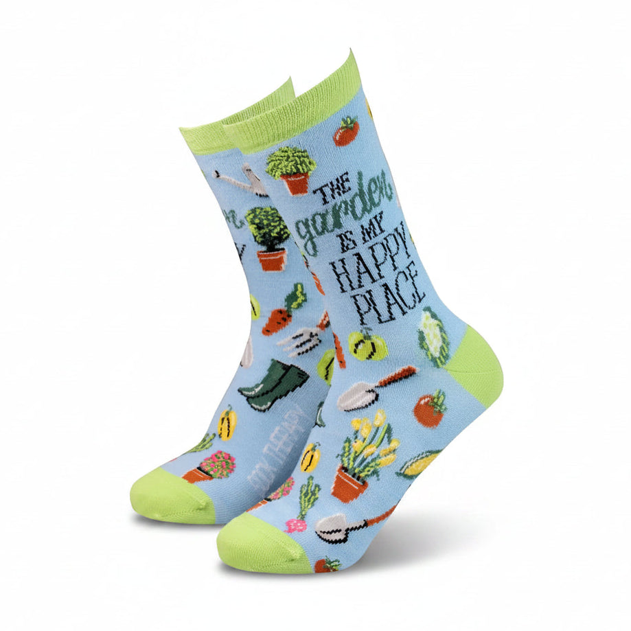 Gardening-themed socks with text and illustrations on a light blue background