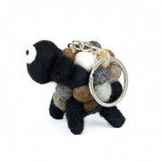 Felt sheep keyring in natural cream and brown wool, on a plain white background.