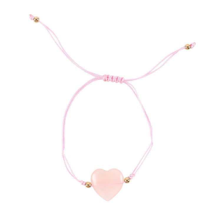 Delicate rose quartz beaded bracelet with heart charm, photographed on a flat lay display card.