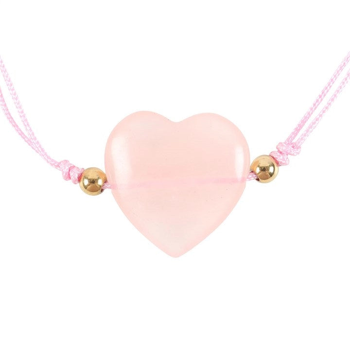 Pink heart-shaped pendant on a pink cord with gold beads against a white background.