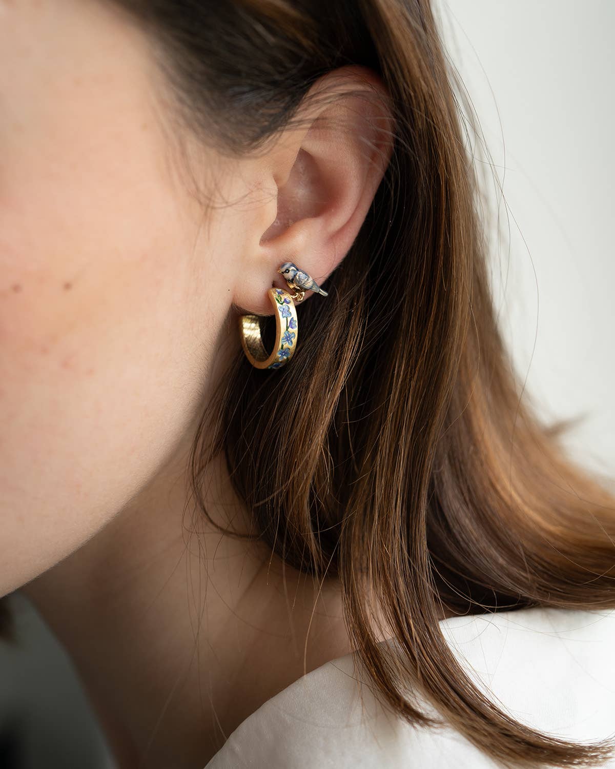 Enamel blue tit stud earrings, close-up product detail shot