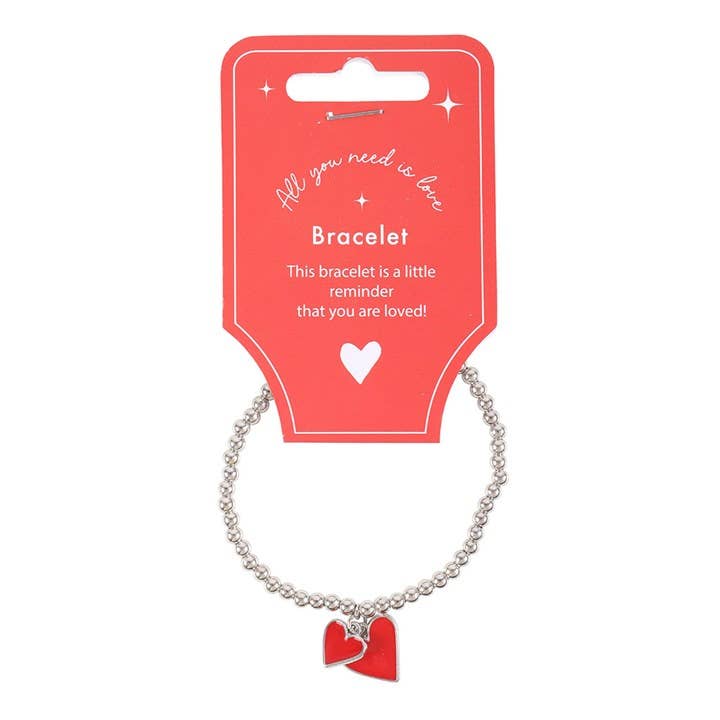 Detail view of red enamel heart charm on bracelet