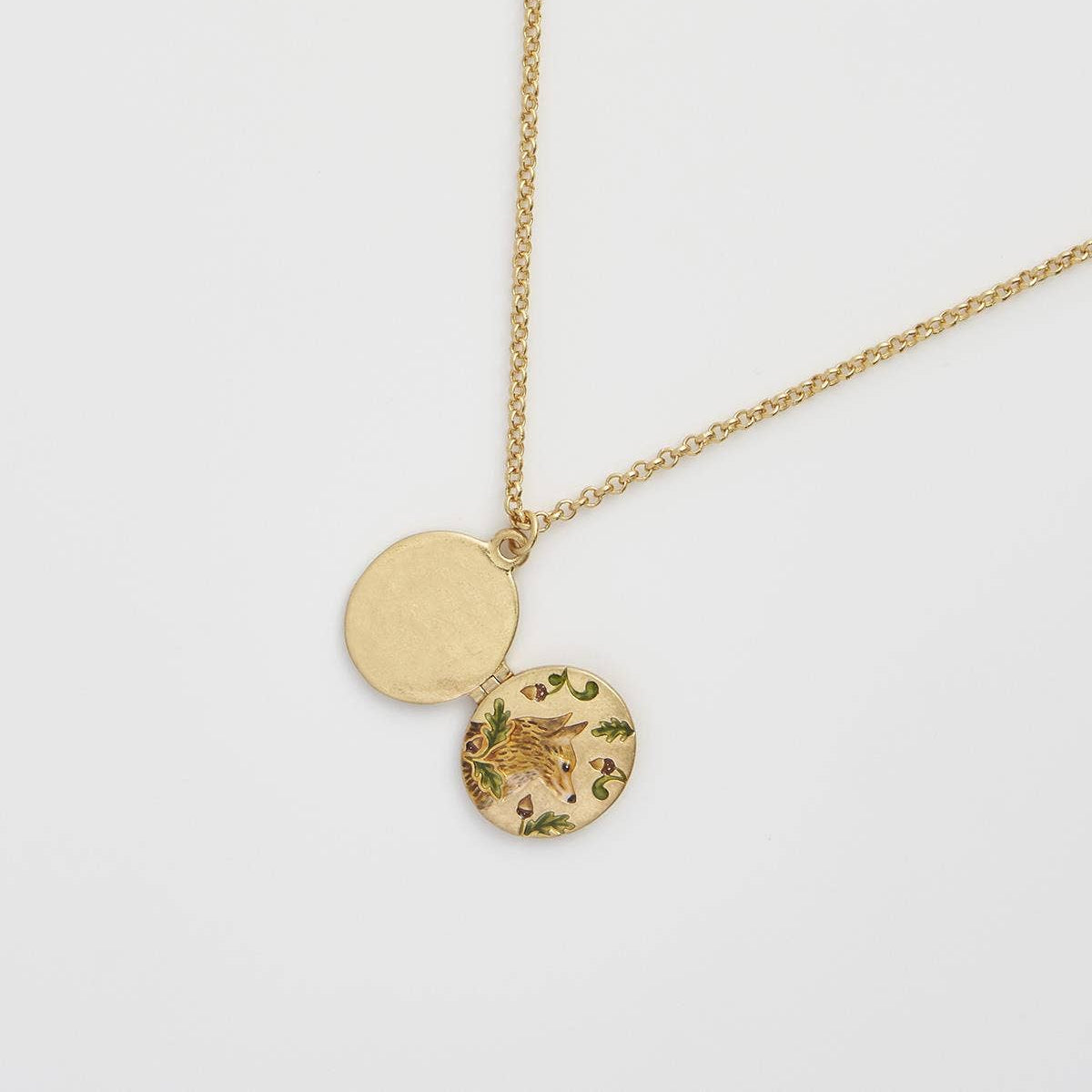 Fox and Acorn locket open showing space for a photo inside