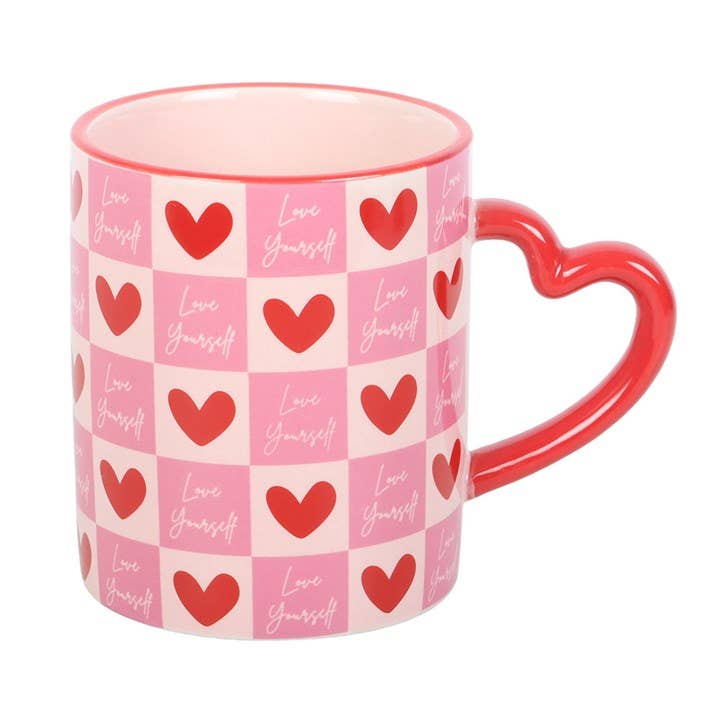 Angled view of pink heart mug with heart-shaped handle