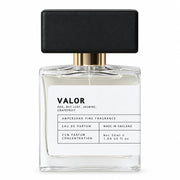 Valor eau de parfum bottle with black cap, front view on cream background