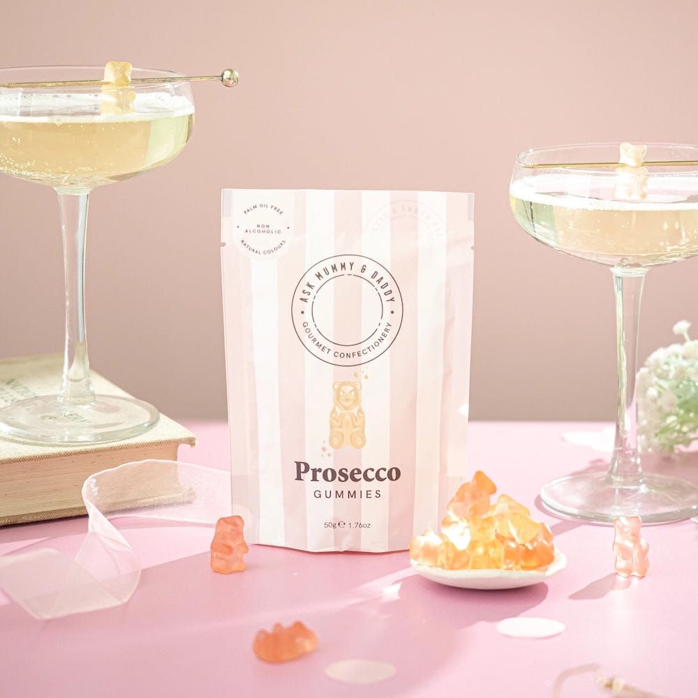 Prosecco Bears pouch displayed with champagne coupes on pink celebration table