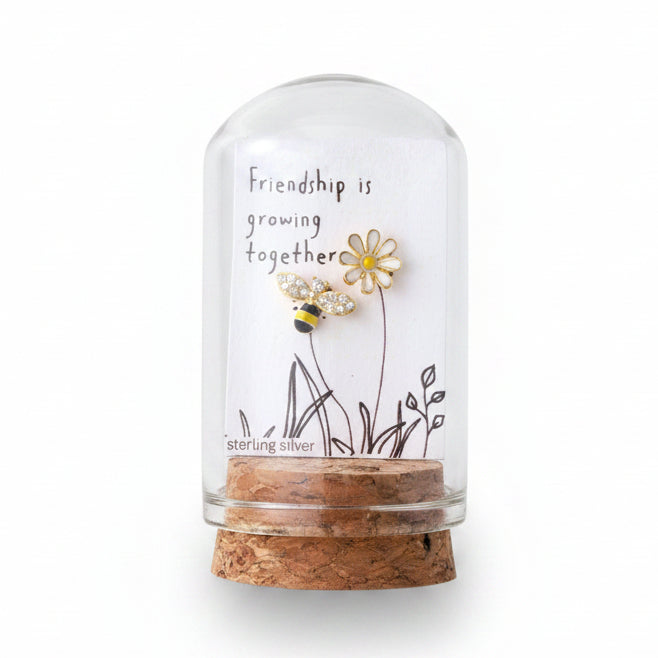 Glass terrarium with friendship card and gold bee and flower earrings held in hand