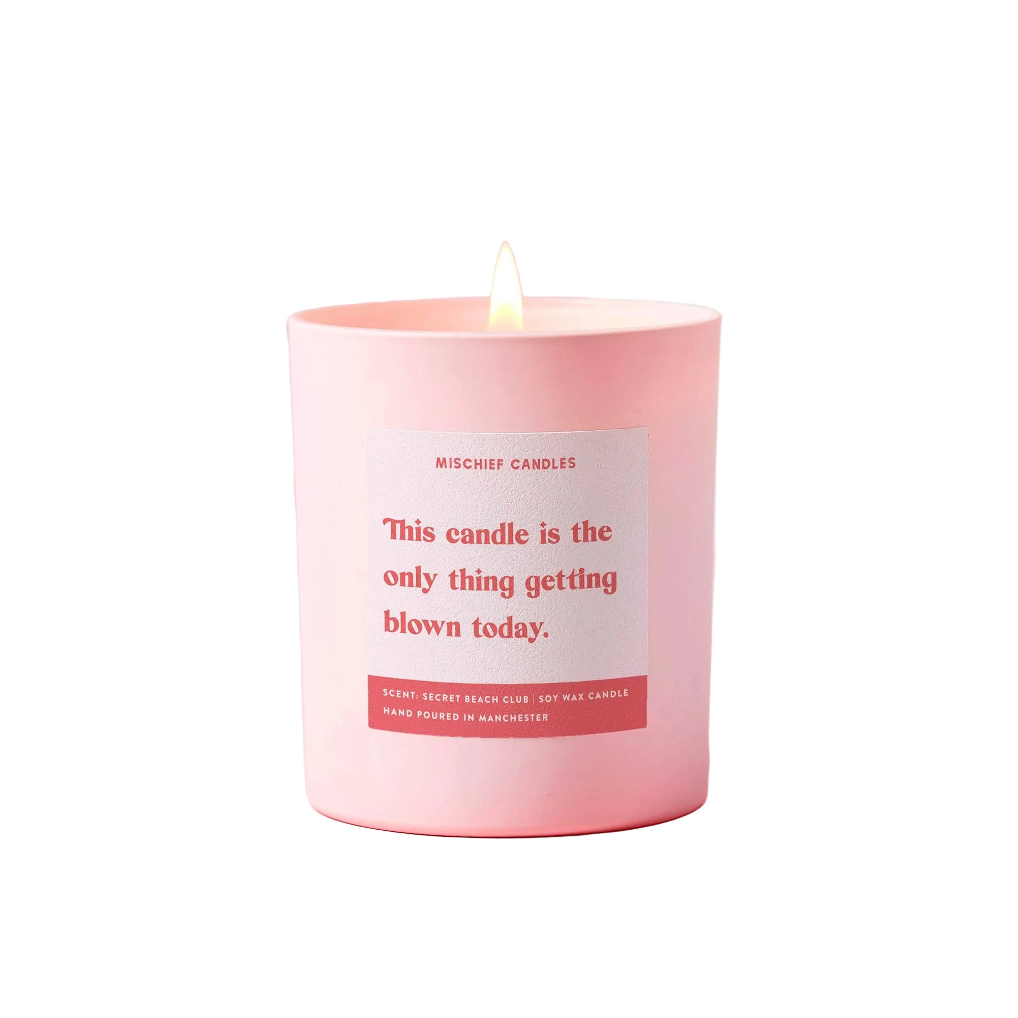 Pink candle with a humorous label on a light pink background