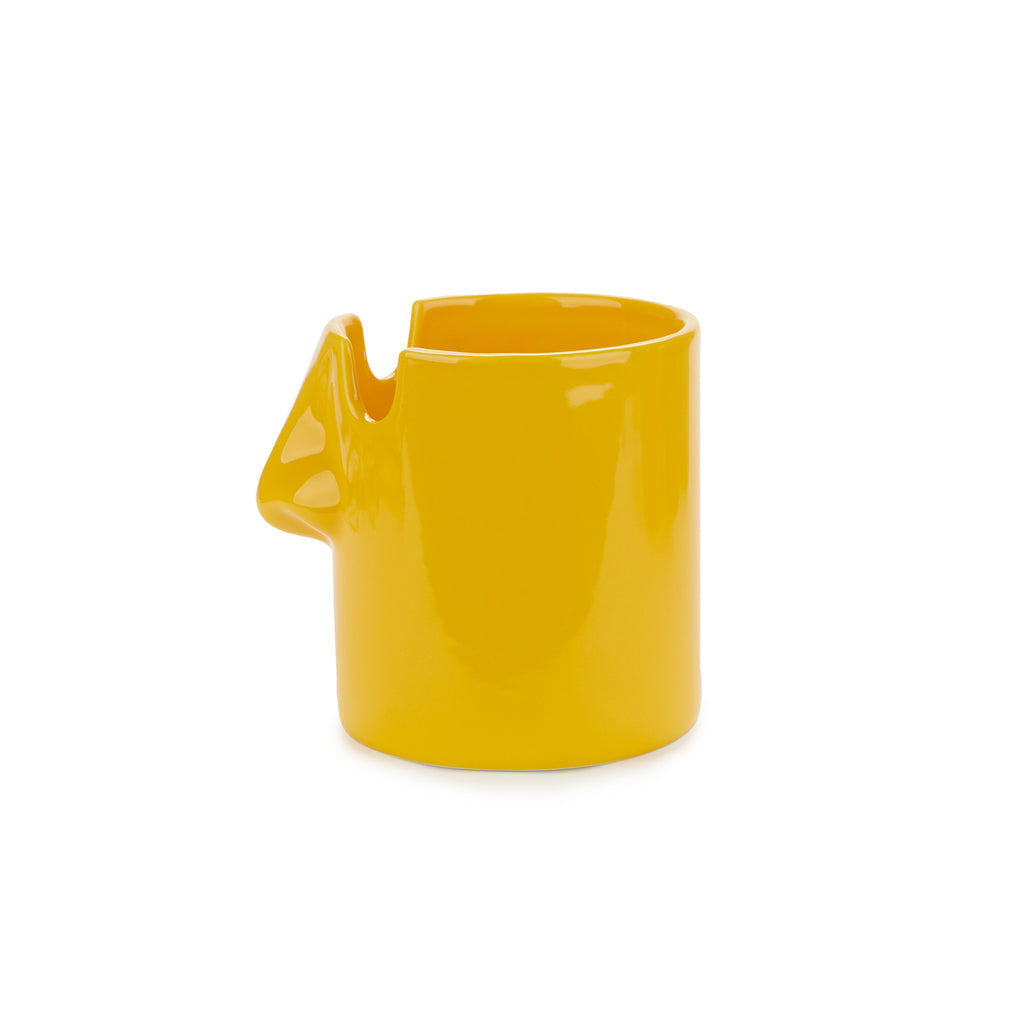 Side profile of the mustard yellow nose-shaped glazed ceramic pen pot
