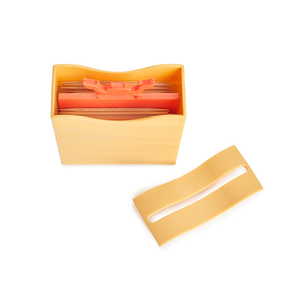 Crab toothpick dispenser opened to show the toothpicks inside and the sliding lid