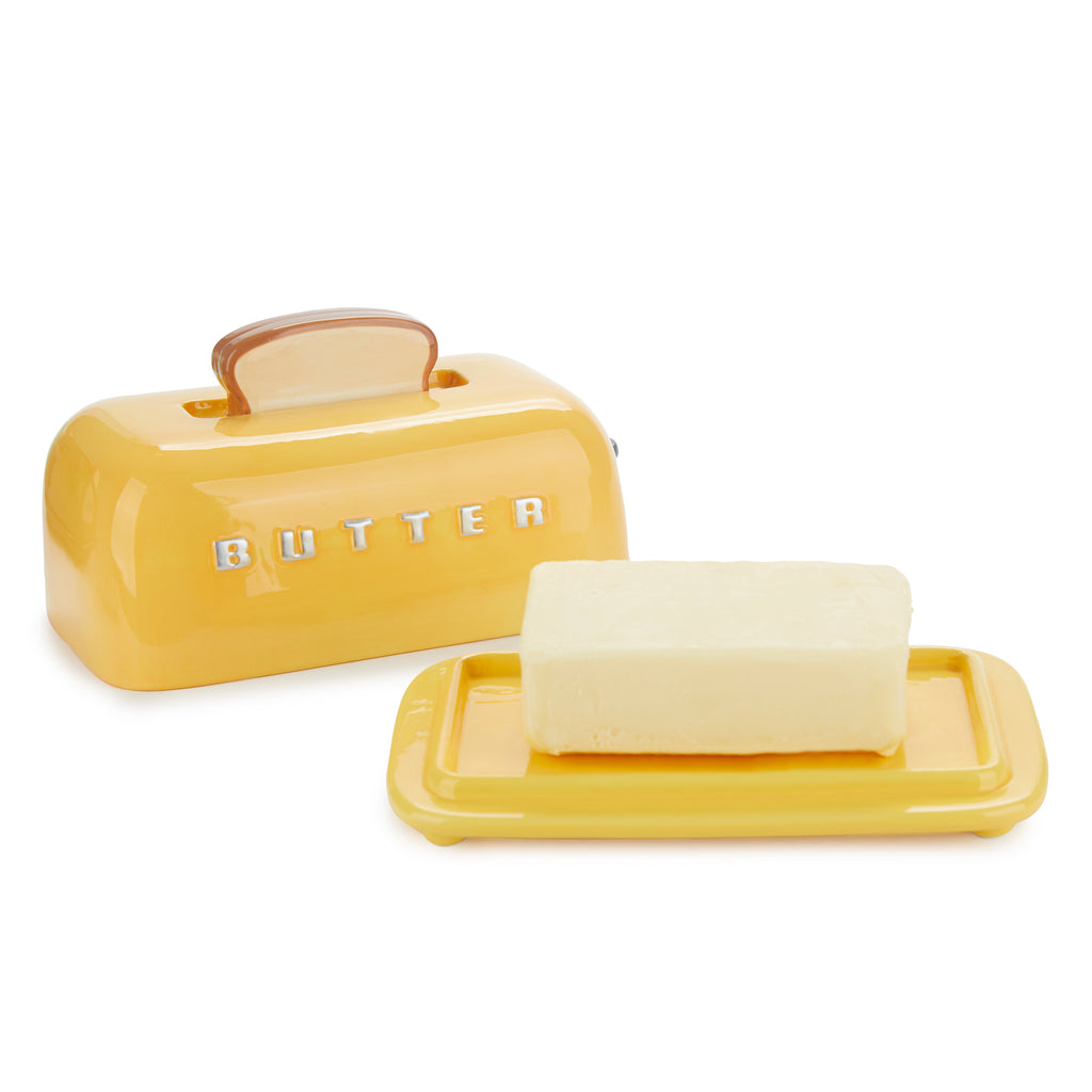 Toaster butter dish with the lid lifted off and a block of butter on the tray