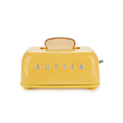 Mustard yellow toaster-shaped butter dish with raised BUTTER lettering on white
