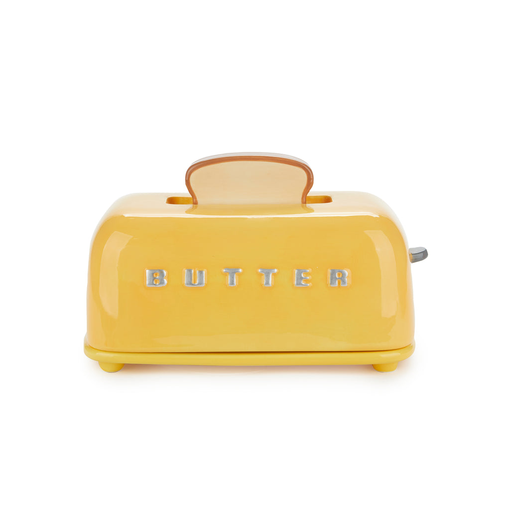 Mustard yellow toaster-shaped butter dish with raised BUTTER lettering on white