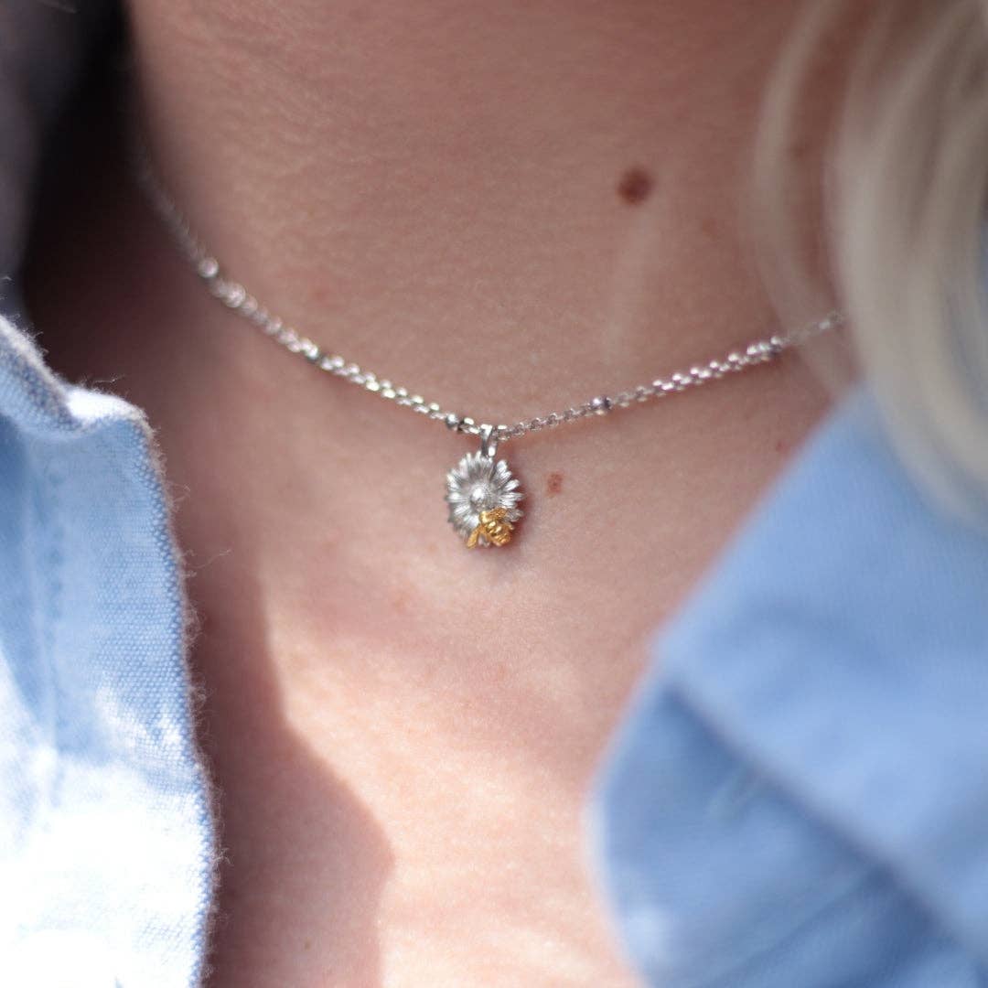 Two-tone pendant on presentation showing Bill Skinner branding