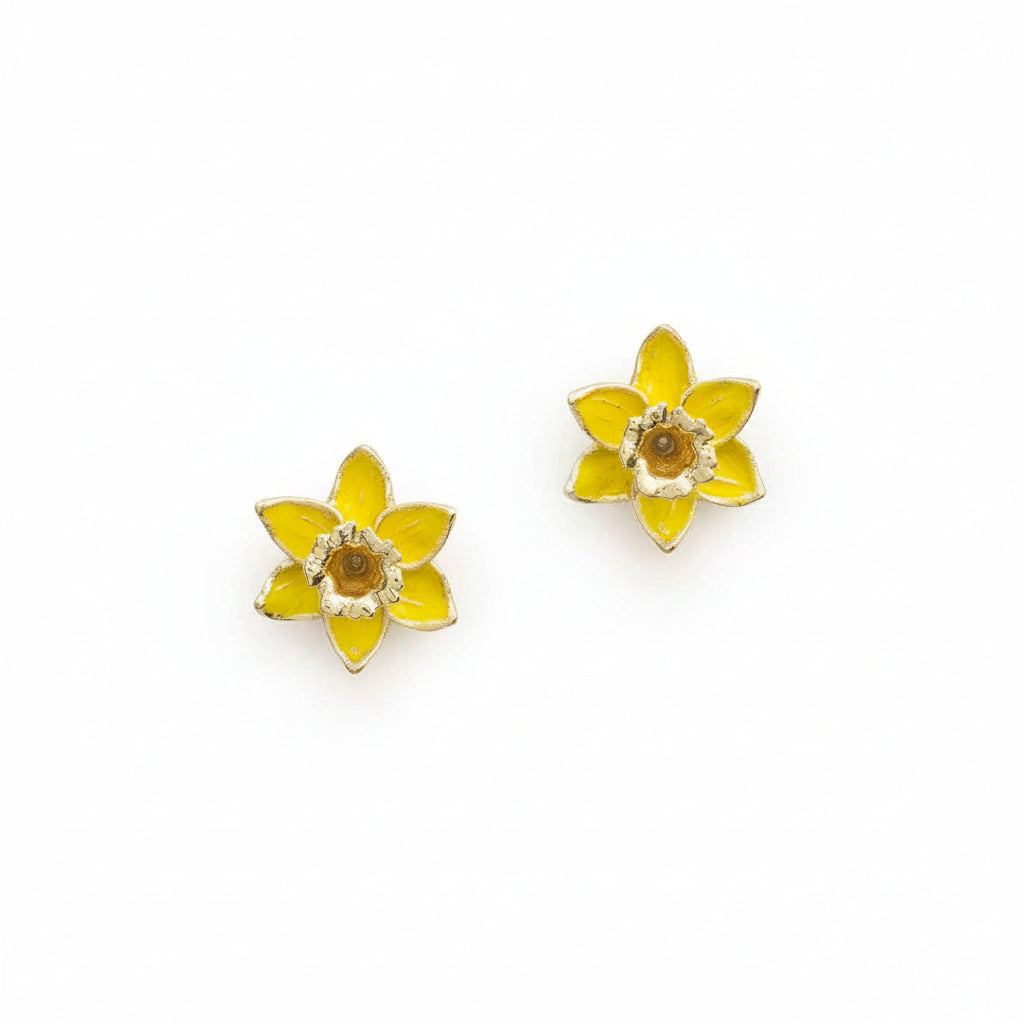 Yellow daffodil stud earrings with gold detailing on white background