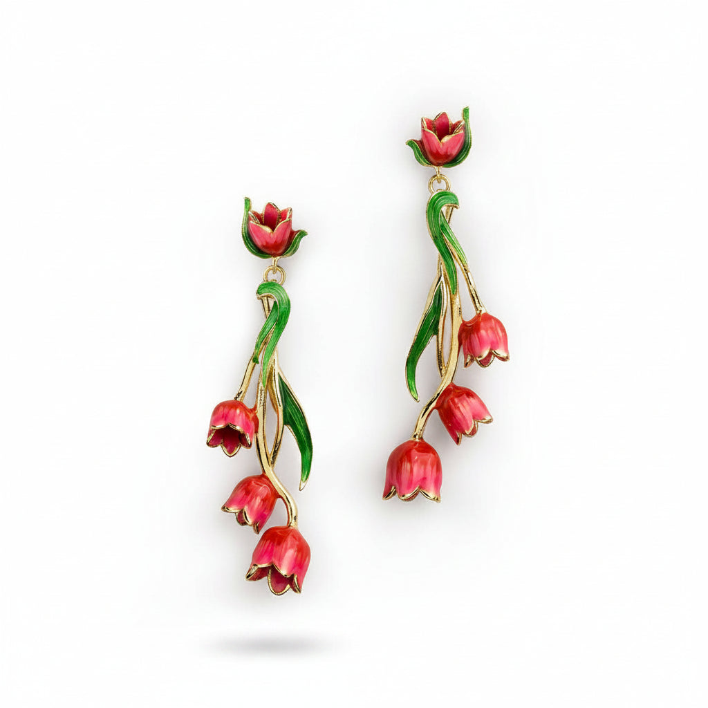 Red tulip drop earrings with gold accents and green enamel leaves on white background