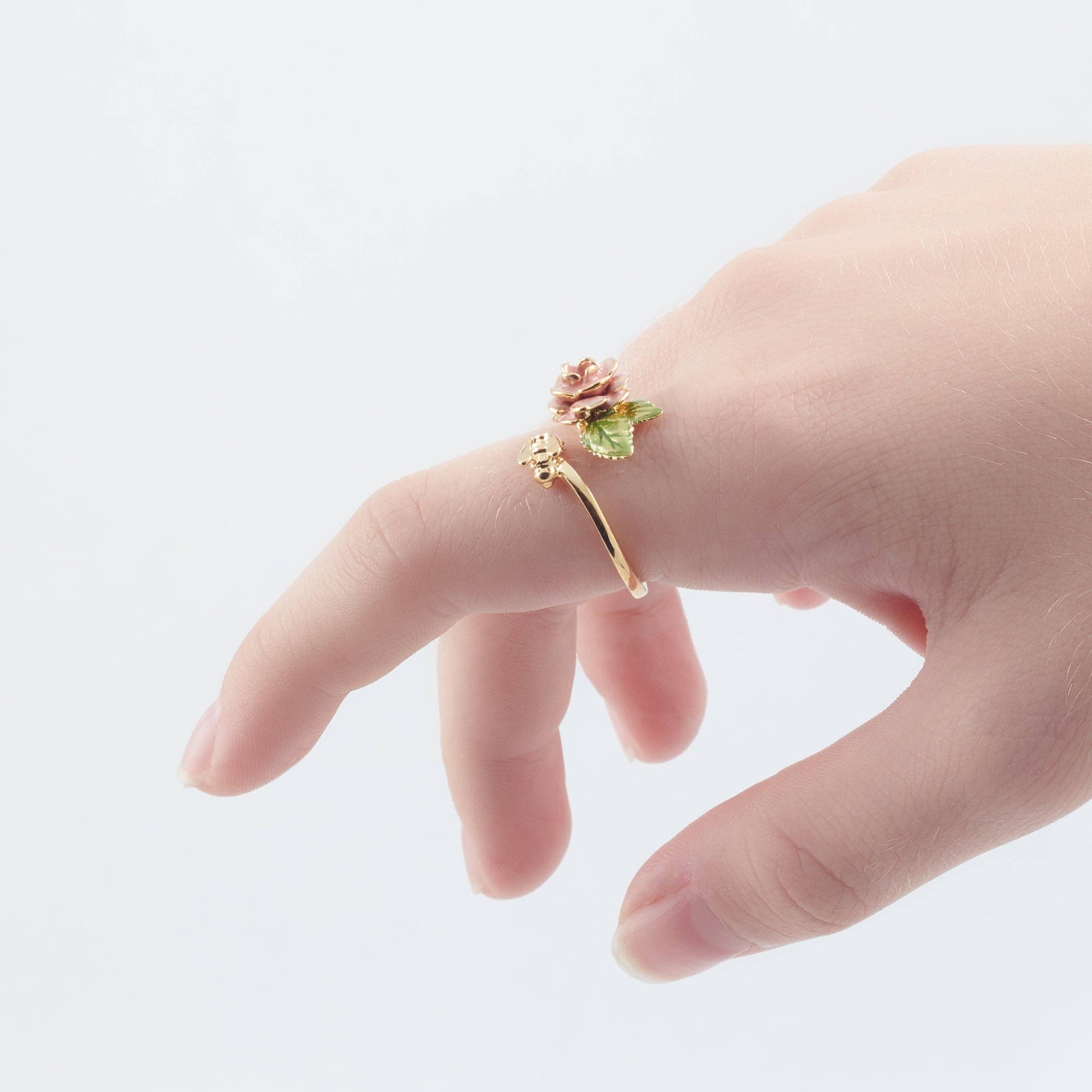 Vintage rose and bee ring worn on hand showing scale