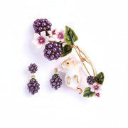 Close-up of Bill Skinner Blackberry & Mouse Brooch featuring hand-painted field mouse holding pearlised blackberries with enamel flowers.