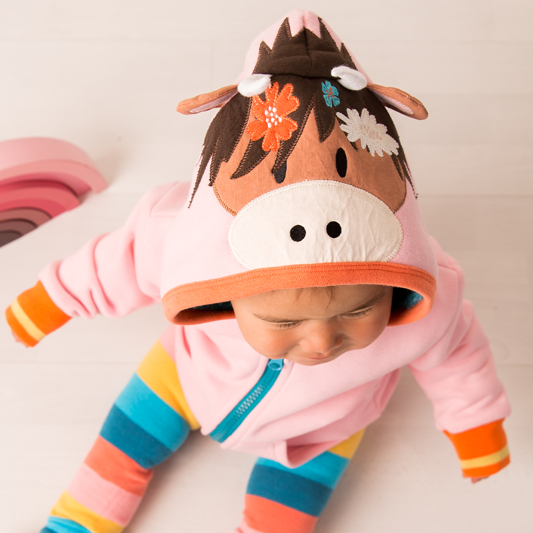 Pink highland cow hood showing ears, horns and flower details