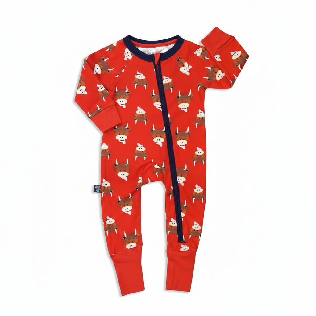 Red highland cow zip-up romper flat lay on blue and beige background