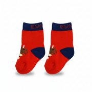 Red highland cow socks pair flat lay on beige background