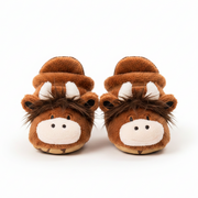Plush highland cow slippers on a white background