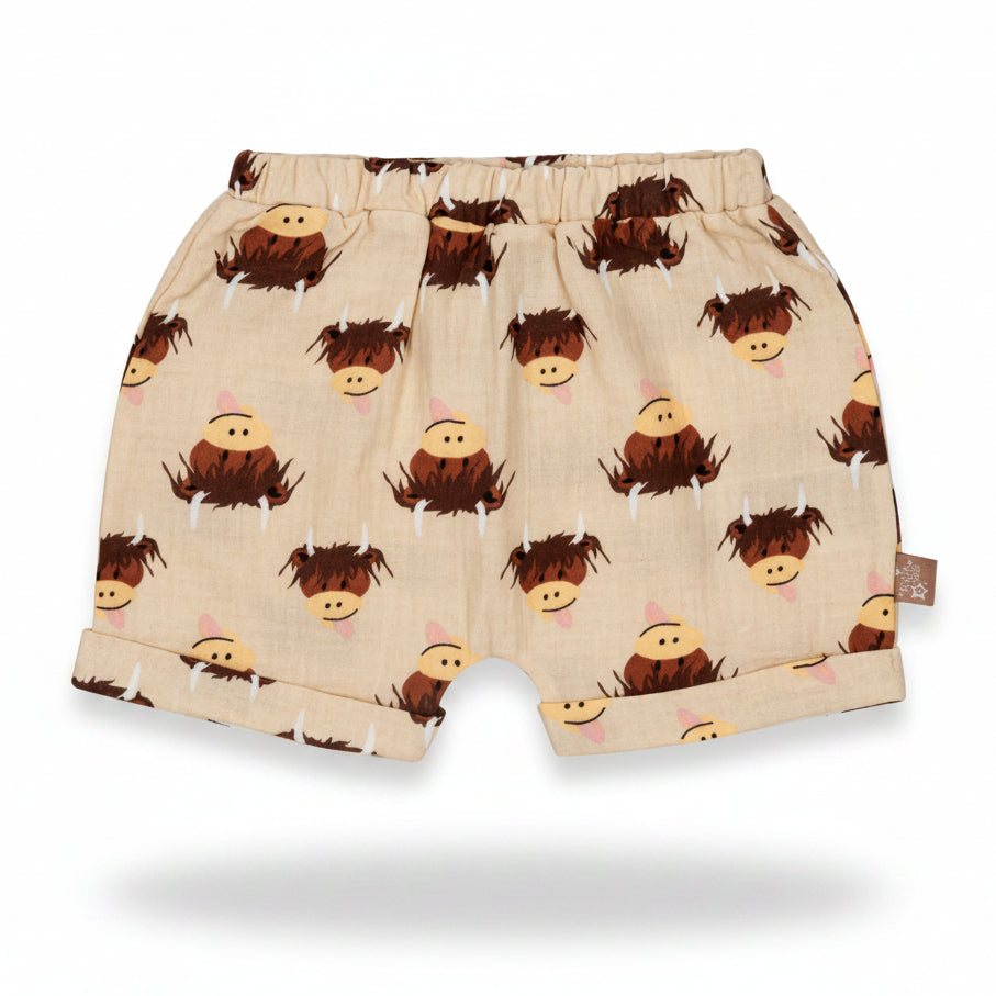 Cream highland cow cotton shorts flat lay on neutral background