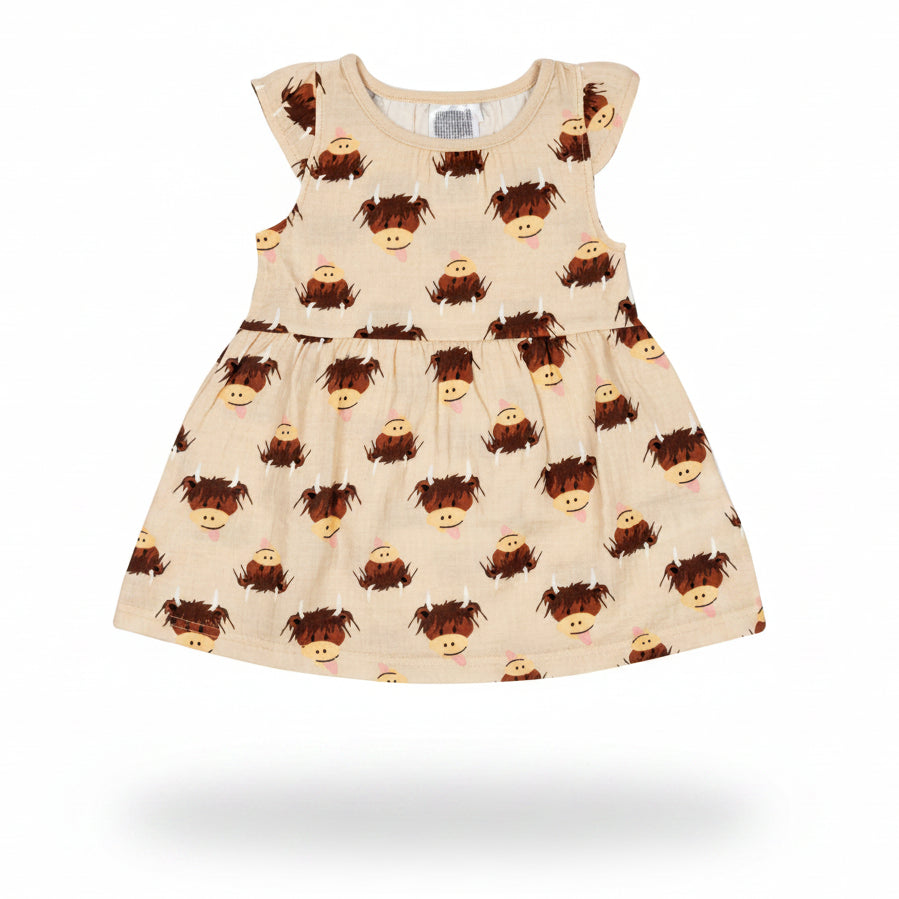 Cream highland cow dress flat lay on neutral background