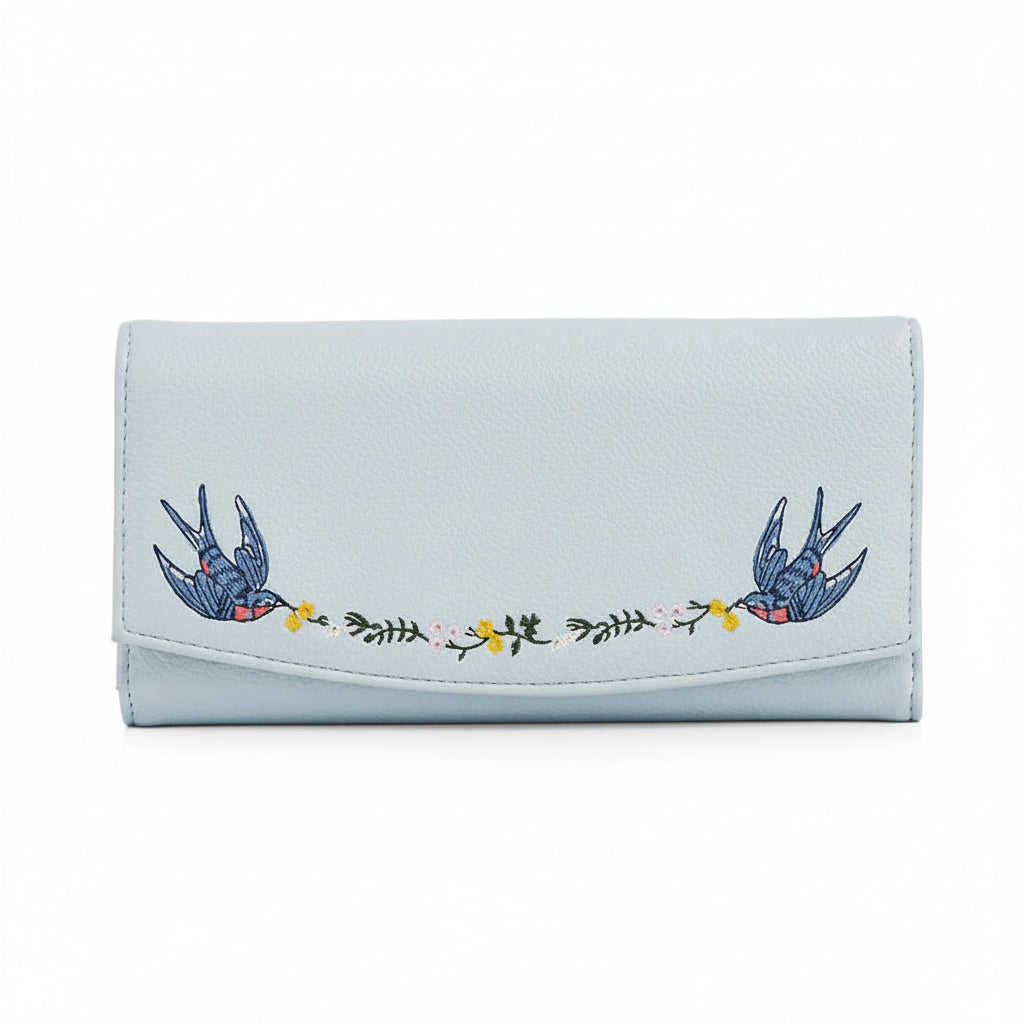 Light blue foldover purse with embroidered birds and floral garland.