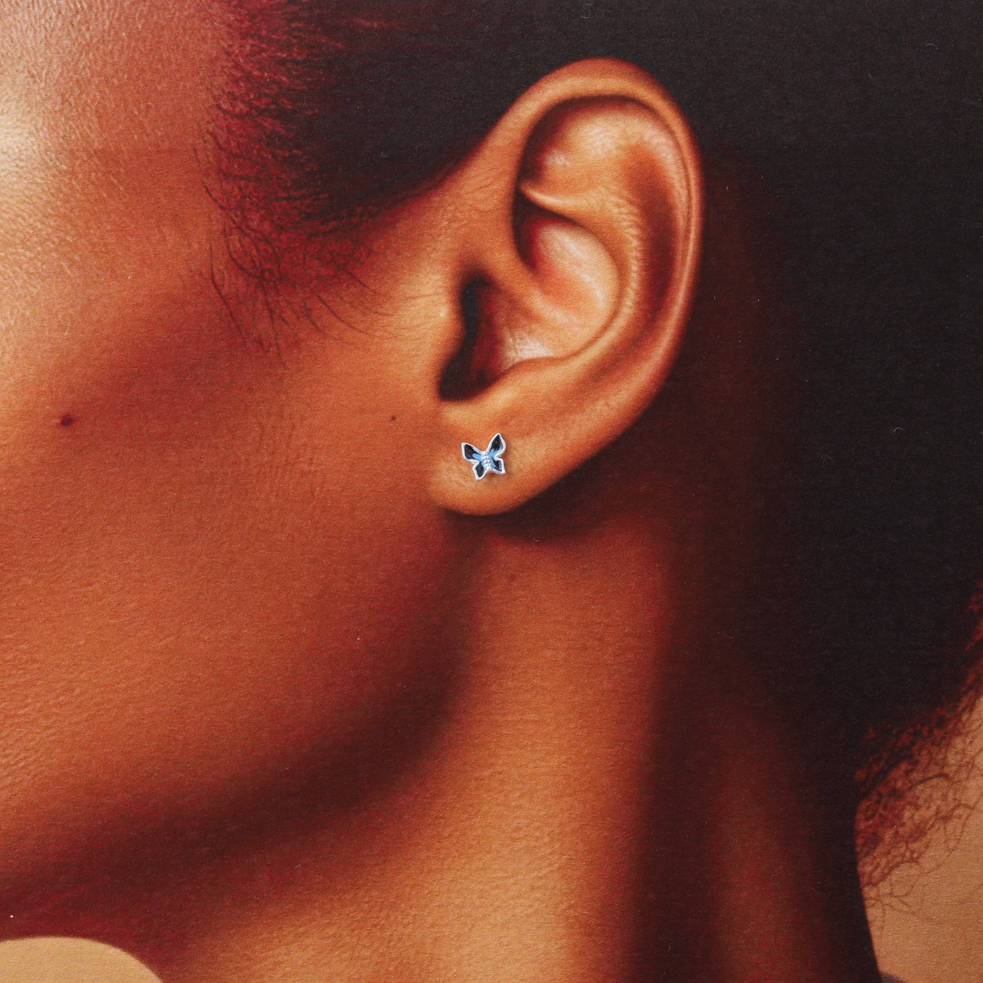Blue enamel butterfly earrings, close-up detail