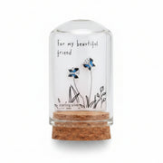 Small jewelry box with butterfly earrings and a personalized message on a textured surface.
