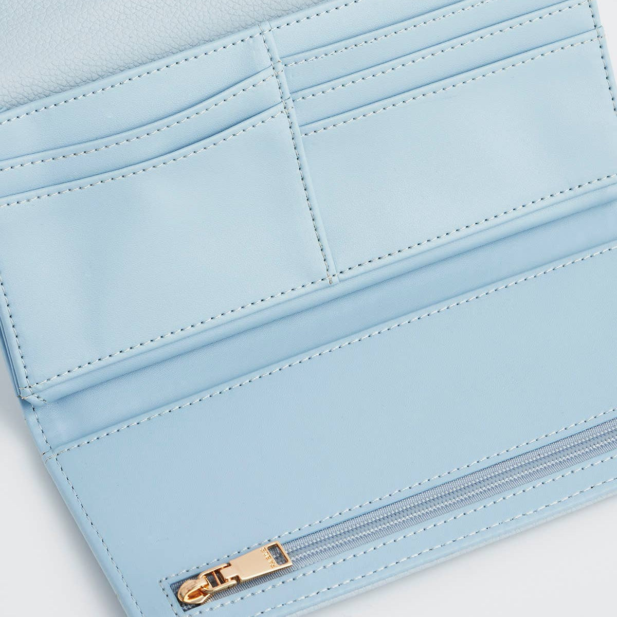 Inside of the purse showing card slots and a zipped compartment.