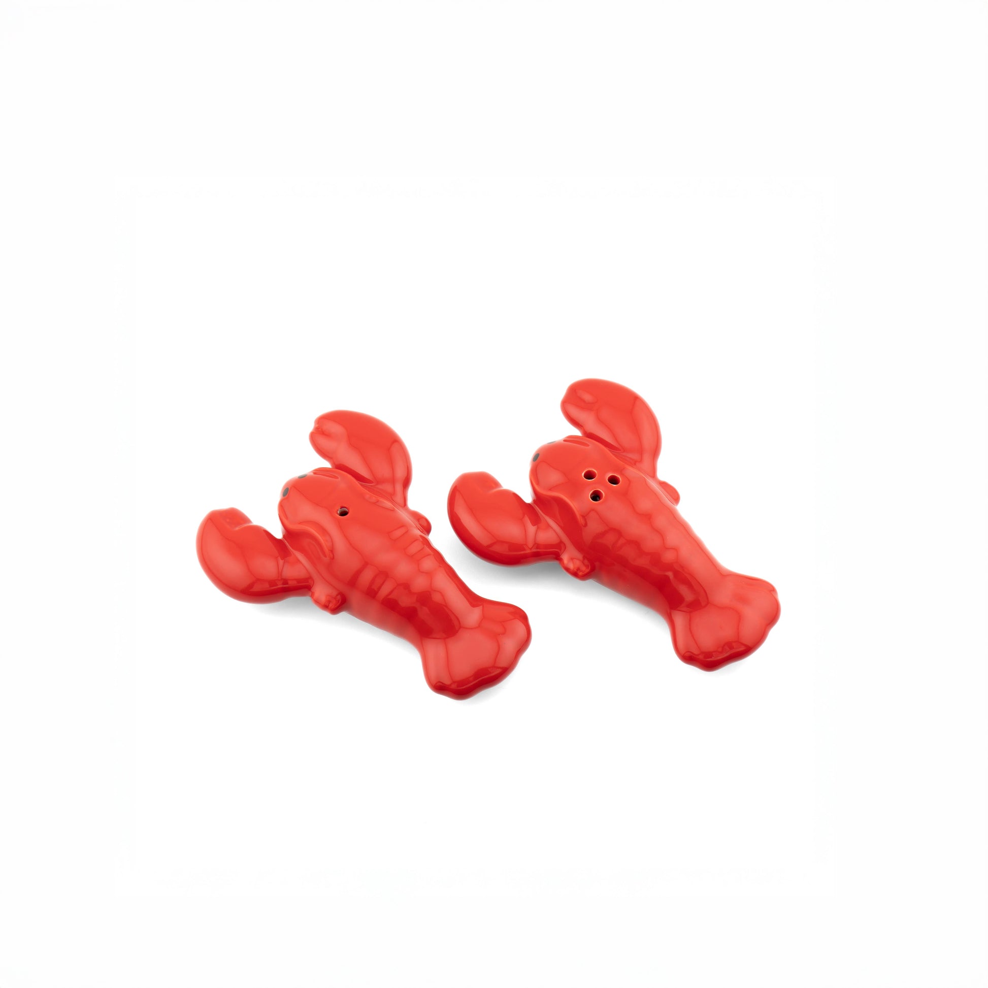Bright red ceramic lobster salt and pepper shakers on a white background