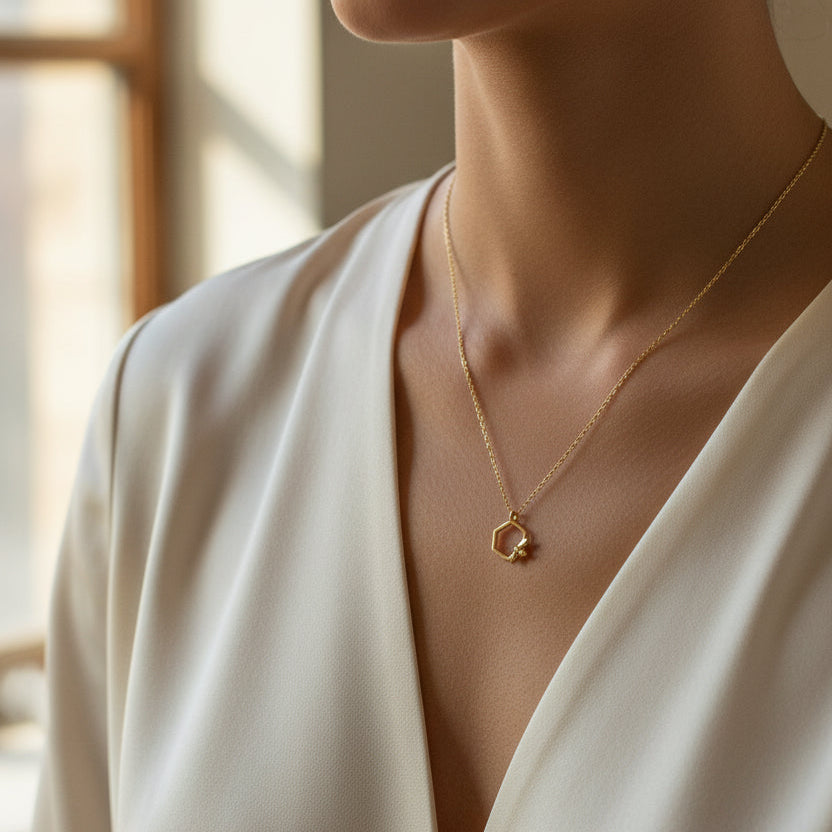 Full view of gold Bumble Bee Hex Pendant necklace with hexagonal charm on delicate chain.